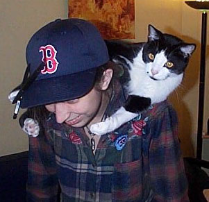 Picture of my cat Lennon, myself, and my
 Bosox cap